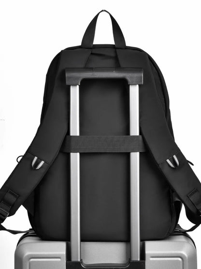 Black multi pocket backpack bag designed for easy travel on rolling luggage with adjustable straps